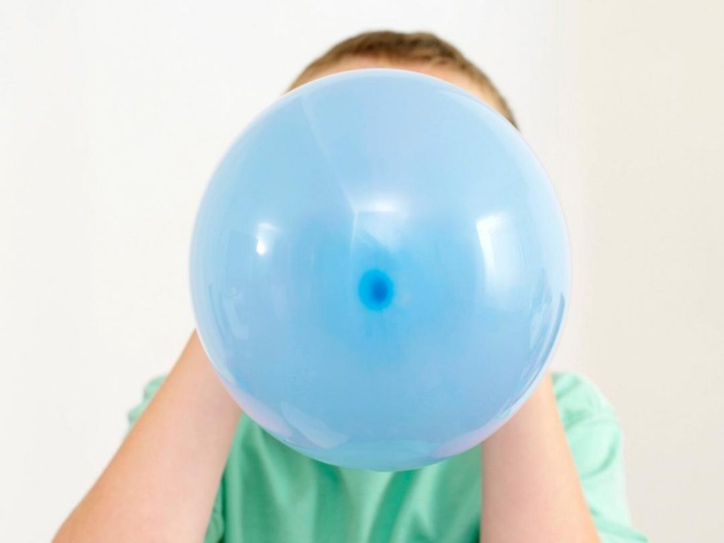 Blowing up a blue balloon